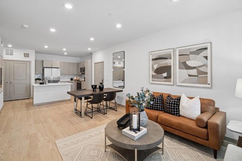 A modern living room with a brown couch and a coffee table.