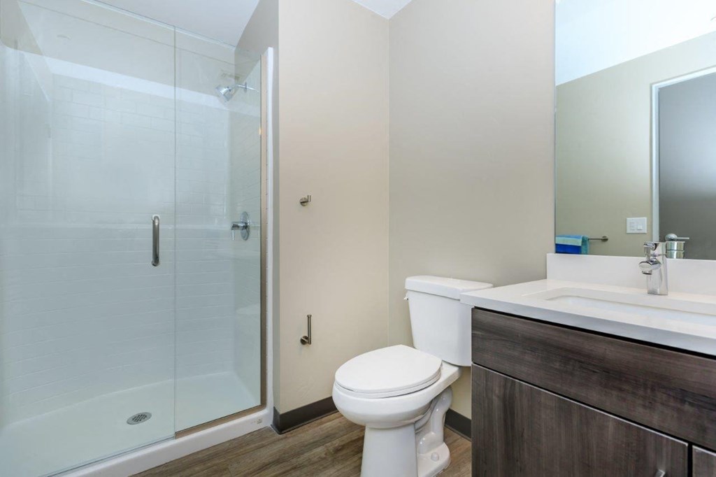 A white toilet sits next to a sink in a bathroom.