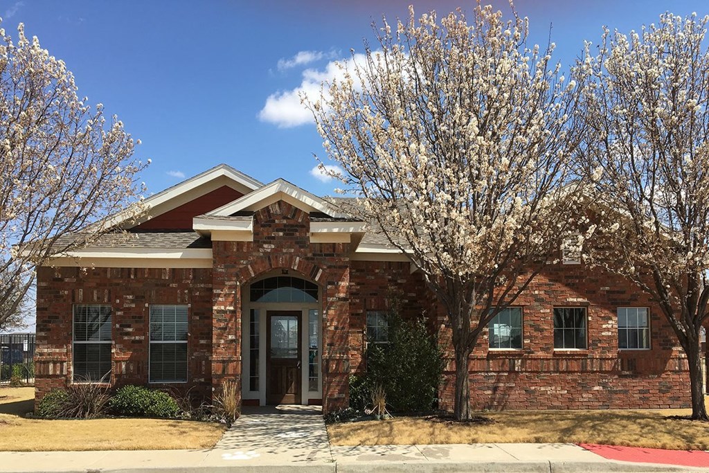 a brick house with a tree in front of it