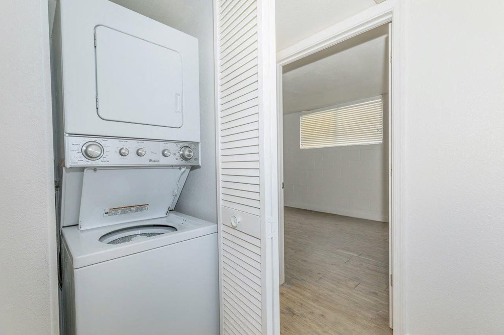 A white oven with a stove top and a microwave is in a kitchen.
