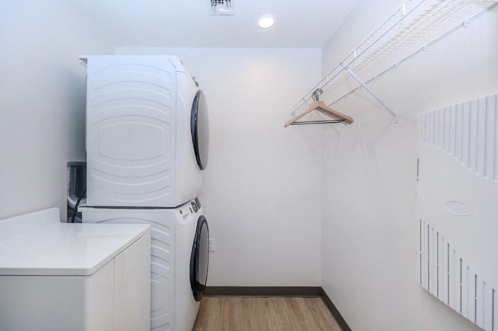 A white washing machine is in a small laundry room.