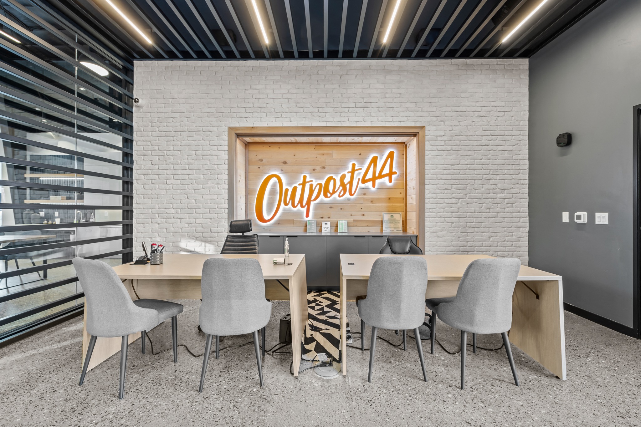 a conference room with tables and chairs and a sign on the wall