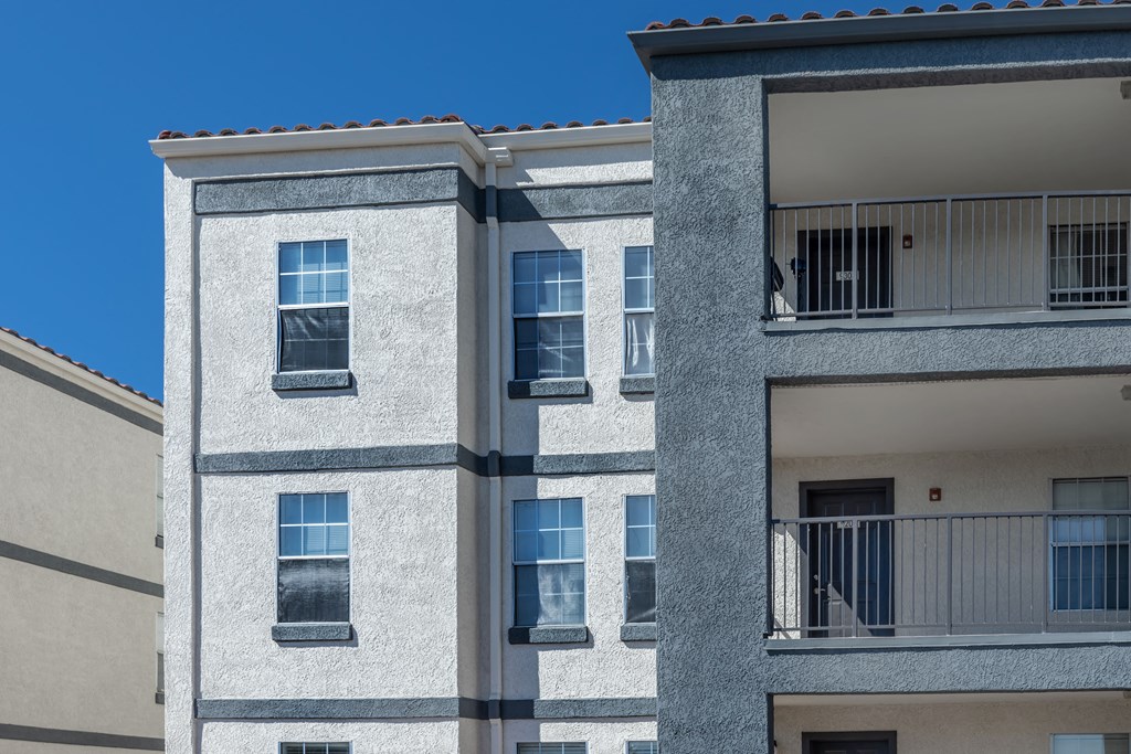 A tall building with a balcony on the top floor.