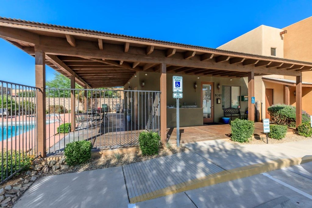 A covered outdoor area with a pool and a parking sign.