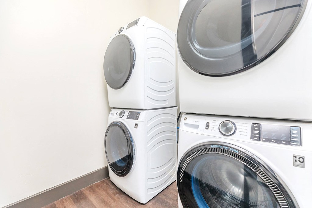 A white washing machine and dryer stacked on top of each other.