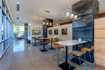 A modern dining area with a long table and chairs.