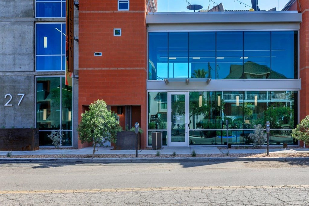 A building with a red brick facade and large glass windows.