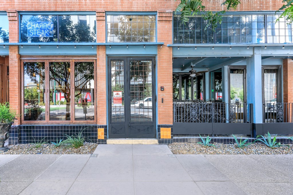 A brick building with a sign that says Charcoal Steak.