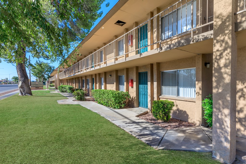 A row of apartment buildings with blue doors and windows.