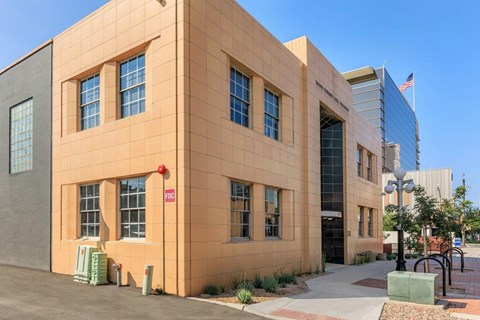 A building with a red sign on the left side of it.