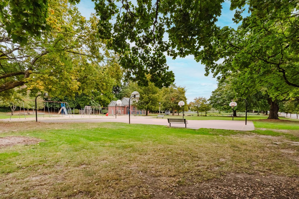 A park with a playground and a picnic table.