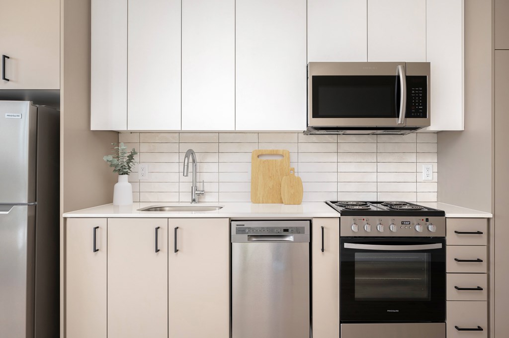 MERX Slabtown Portland Oregon kitchen with white cabinets and a  microwave above the stove.