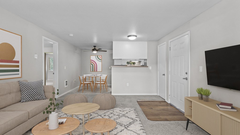 A living room with a couch, a coffee table, and a television.