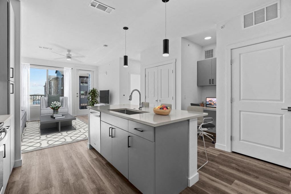 an open kitchen with a large island and a living room