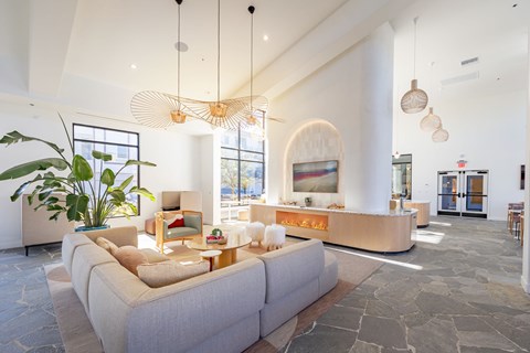 A living room with a large couch and a chandelier.