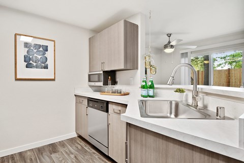 the kitchen of an apartment with stainless steel appliances and a sink