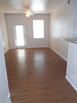 an empty living room with a wood floor