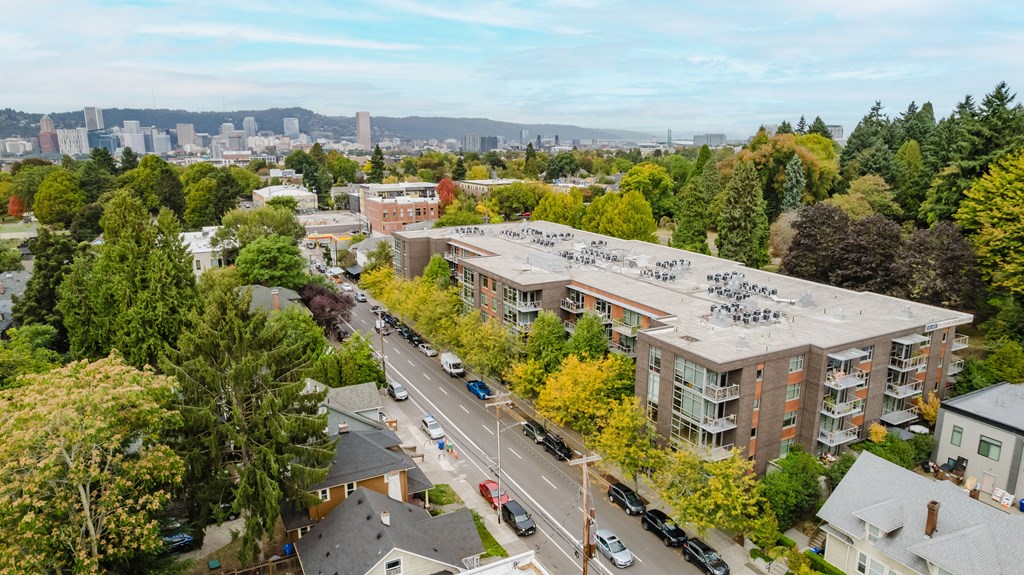 A view of a city from a high vantage point with apartment buildings and cars.