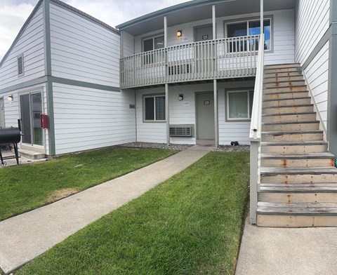 A two-story house with a balcony on the second floor.