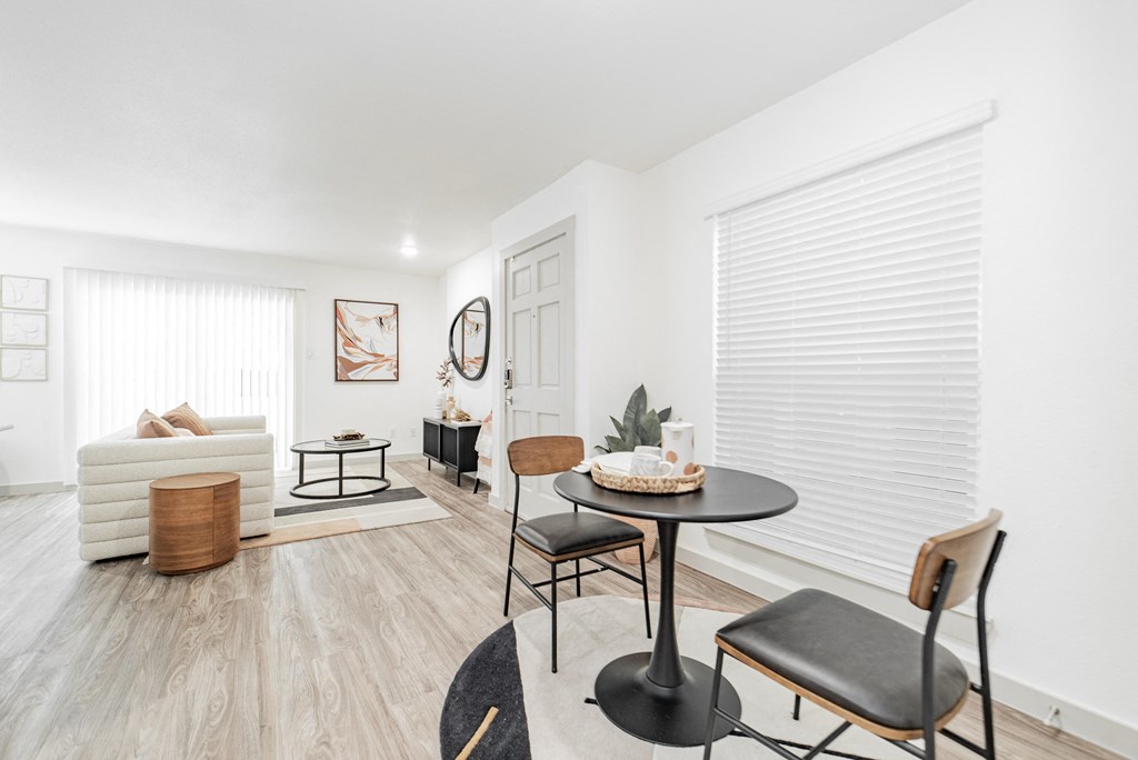 a living room with a table and chairs and a couch