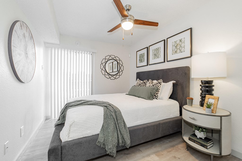 a bedroom with a large bed and a ceiling fan
