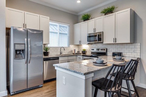 a kitchen with stainless steel appliances and a counter top