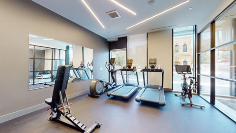 A spacious gym with treadmills, elliptical machines, and other exercise equipment.