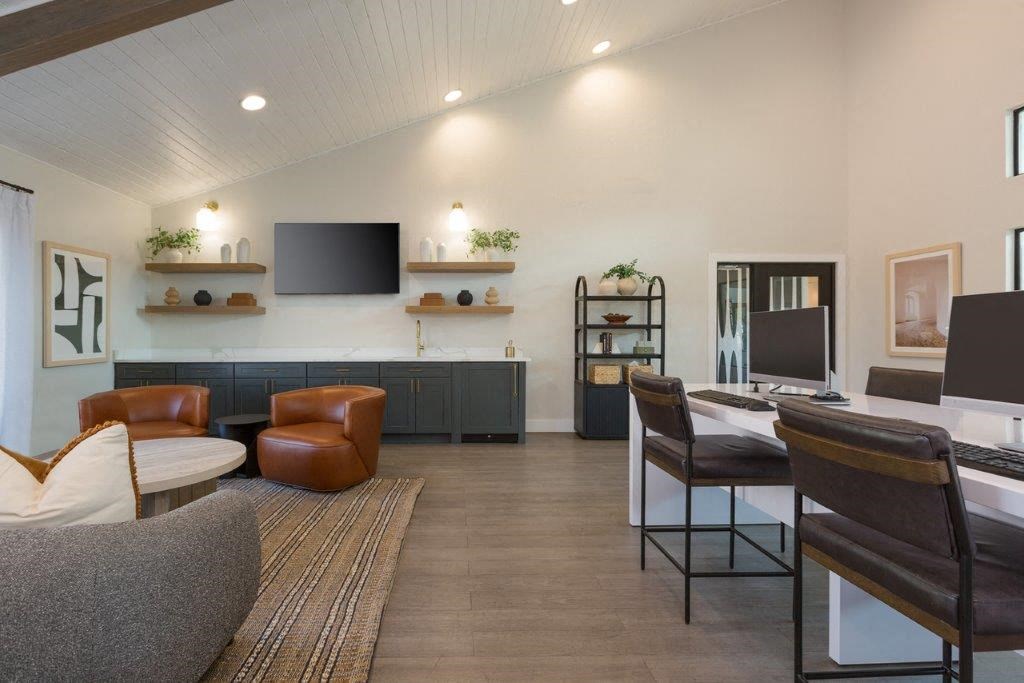 a living room with a table and chairs and a television