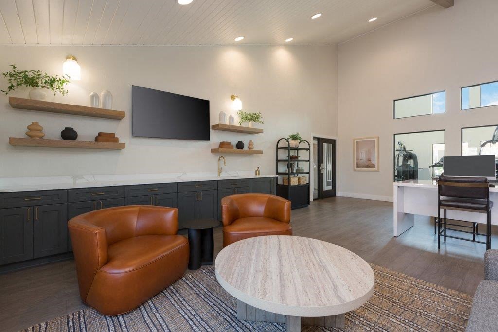 a living room with two leather chairs and a table