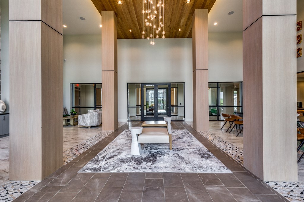 a large lobby with a seating area and a chandelier