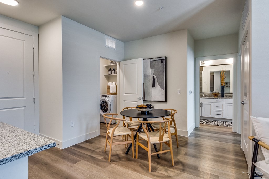a dining room with a table and chairs and a laundry room