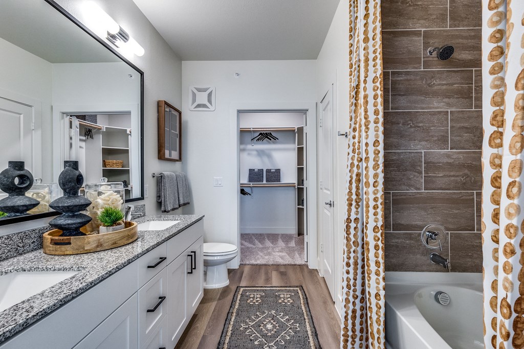 a bathroom with a tub and a shower and a sink