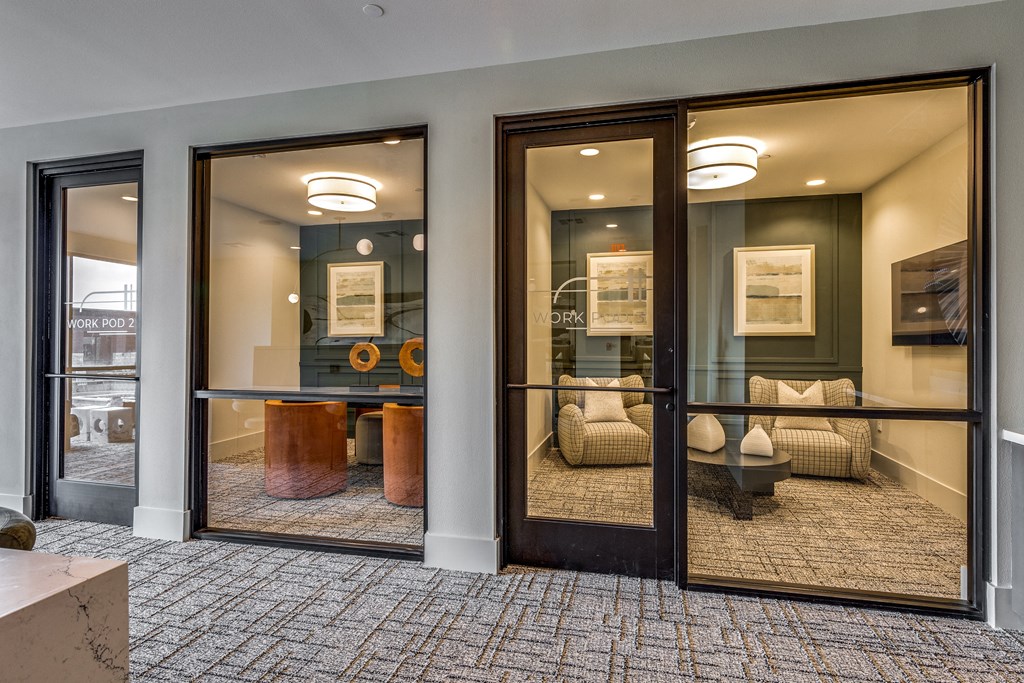 a conference room with large windows and a table and chairs