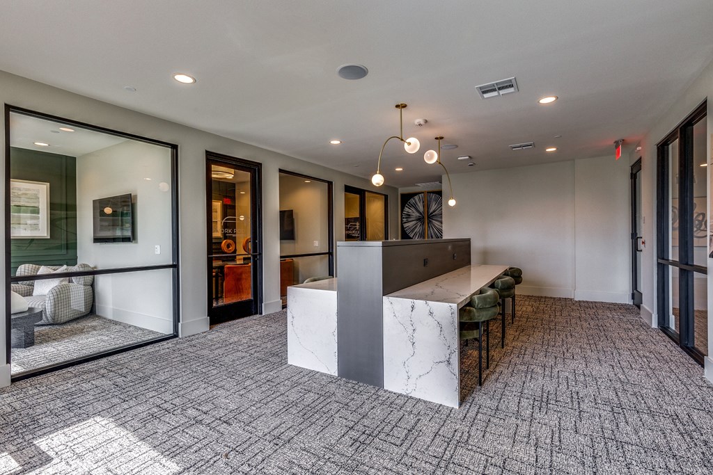 a large lobby with a reception desk and a table with chairs