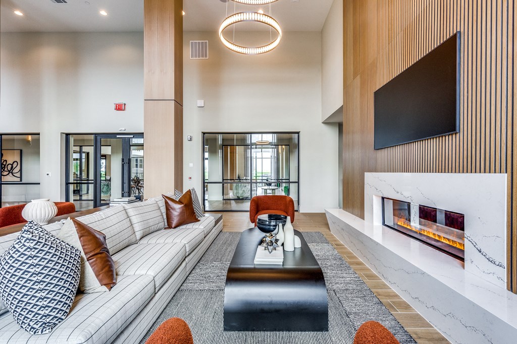 a living room with a white couch and a coffee table and a fireplace