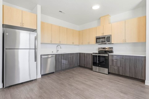 A kitchen with wooden cabinets and stainless steel appliances.