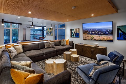 A modern living room with a large couch and a television.