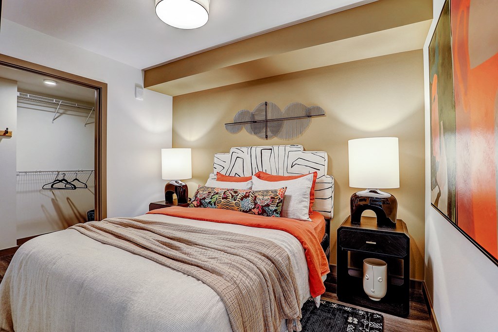 a bedroom with a bed and a door to a closet