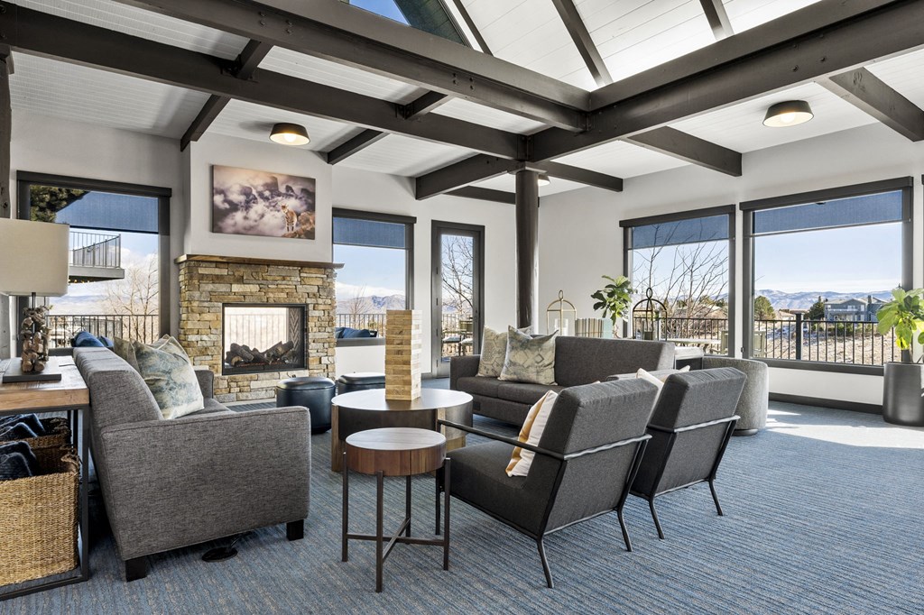 a living room with couches and chairs and a fireplace