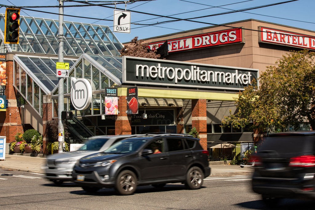 a supermarket with cars driving past it