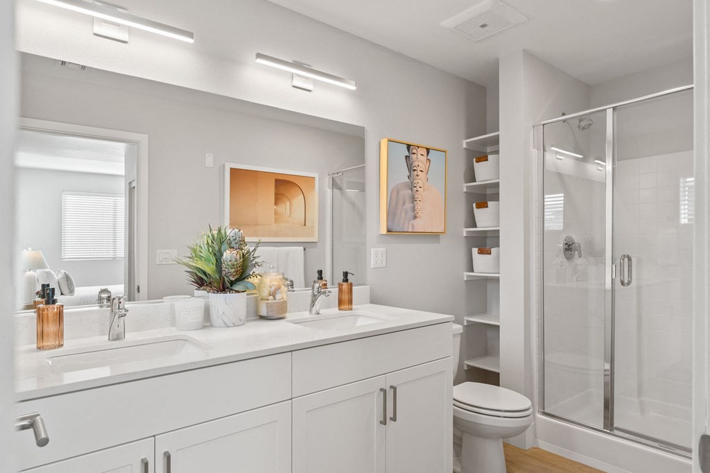 a bathroom with a sink and a shower and a toilet