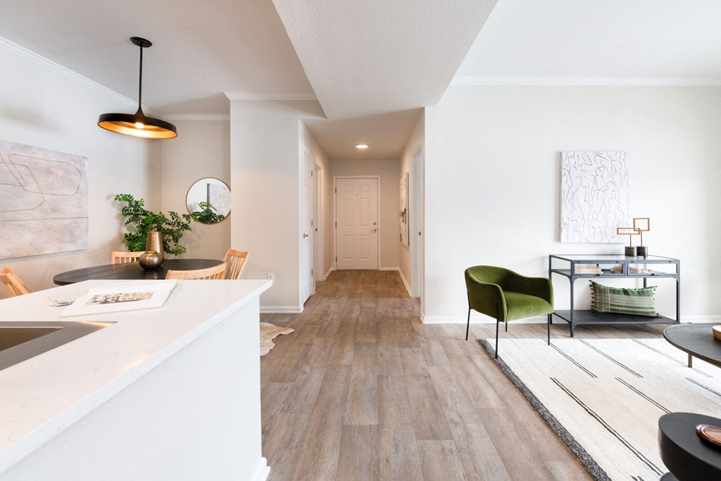 a living area with white walls and hardwood floors