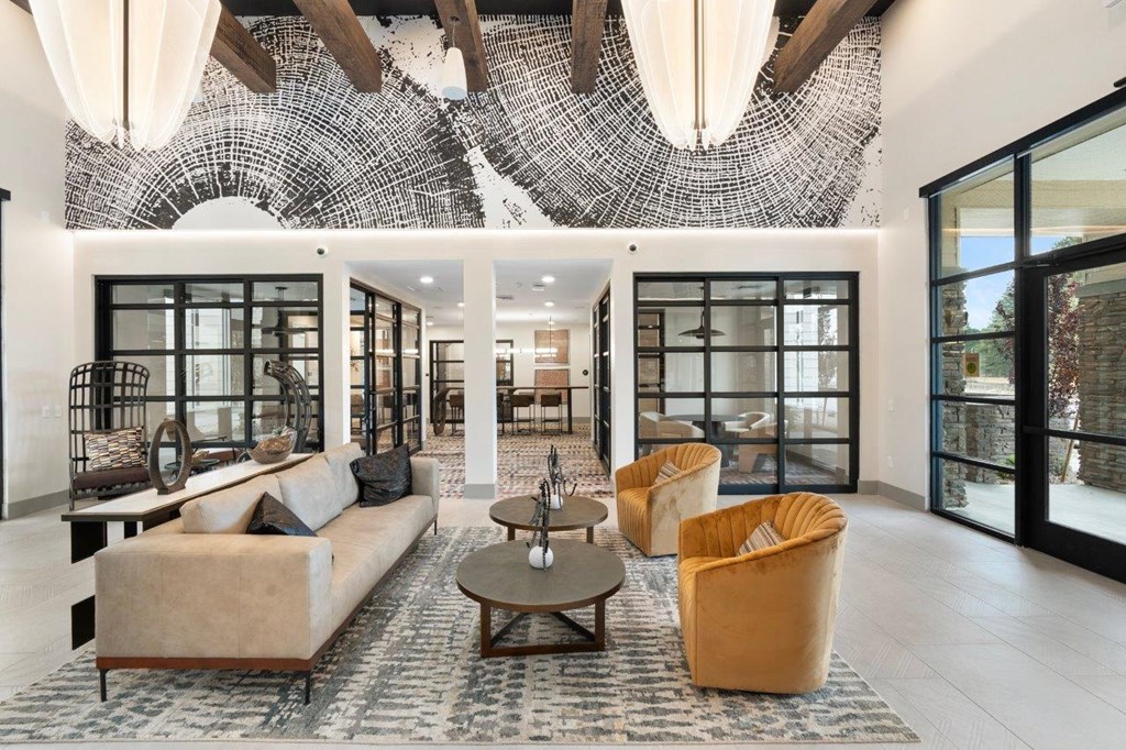 a living room with couches and chairs and a mirrored ceiling