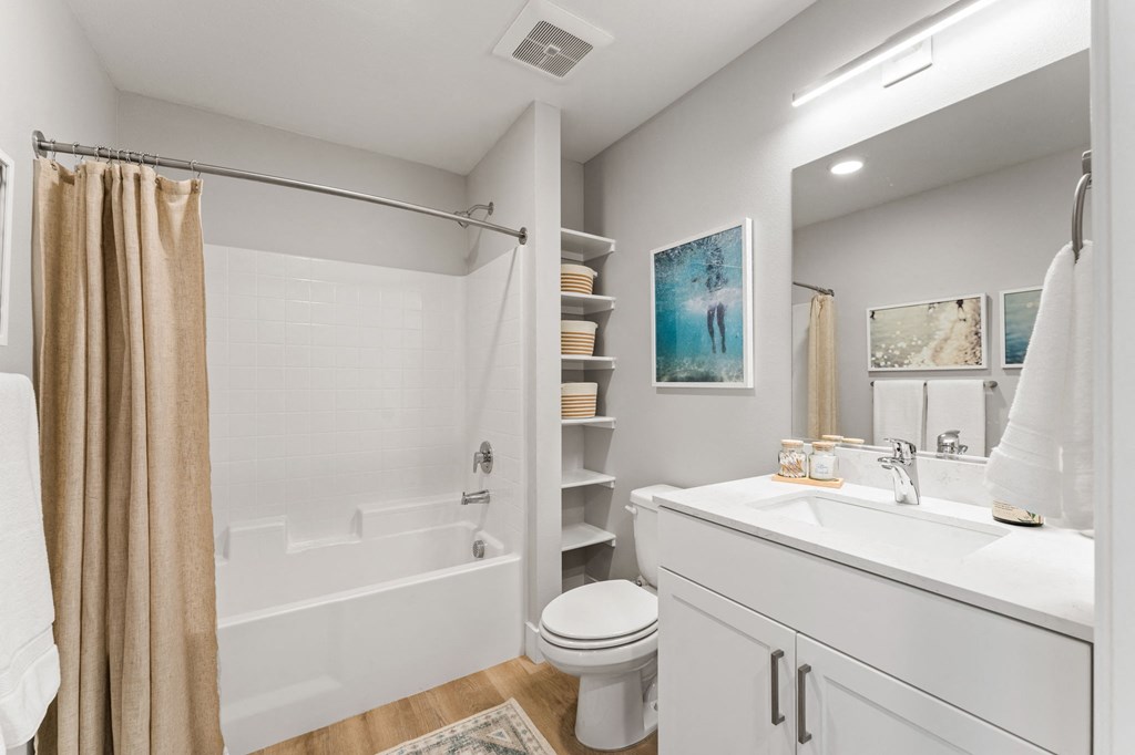 a bathroom with a shower and a toilet and a sink