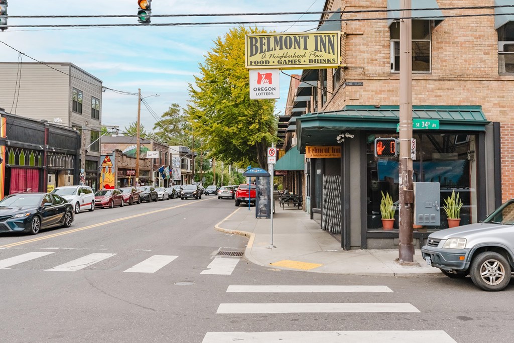 A street view of Belmont Inn with cars parked on the side of the road.