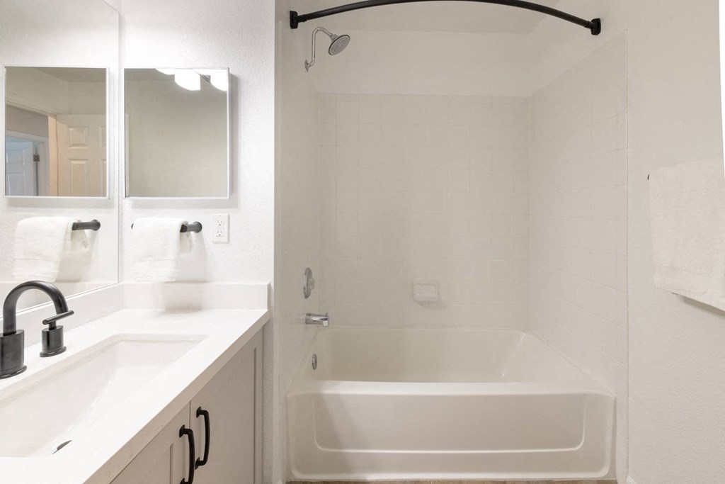 a bathroom with a bathtub and a sink