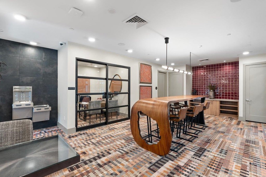 a dining room with a long wooden table and chairs