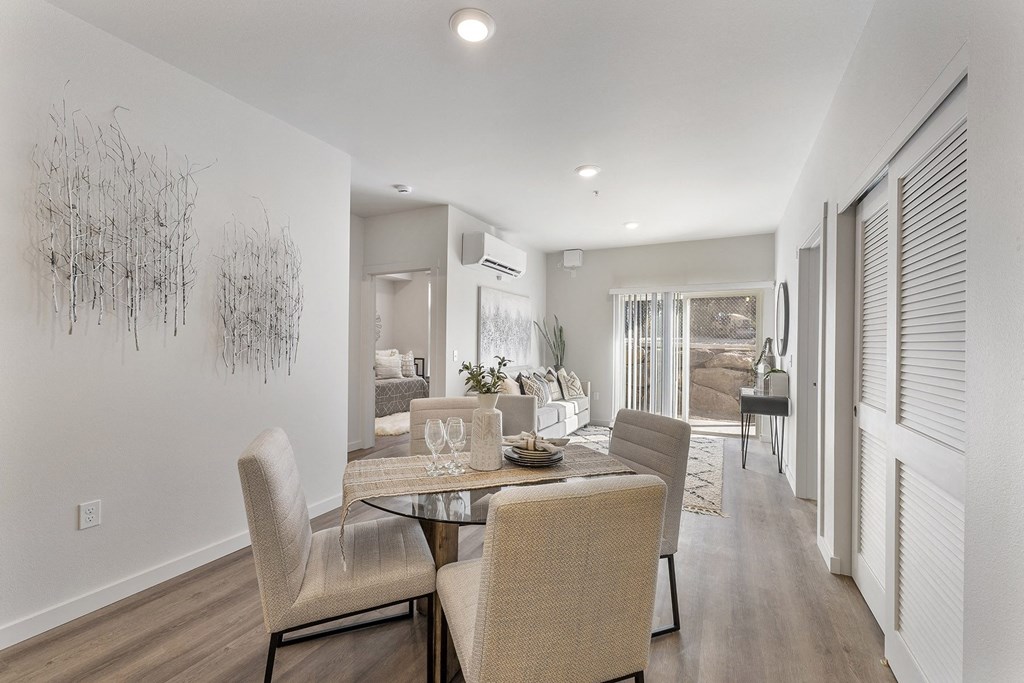 A dining room with a table and chairs.