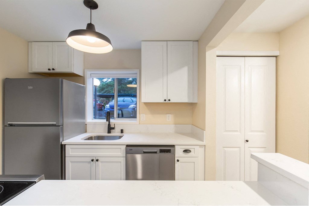 The Reserve at Bucklin Hill Apartments  kitchen with white cabinets and a stainless steel refrigerator