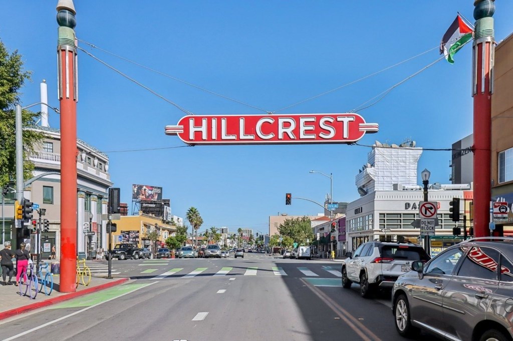 A street view of Hillcrest with cars and a bicycle.
